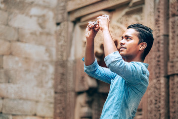 Local tourist takes mobil photo of indian architect sight