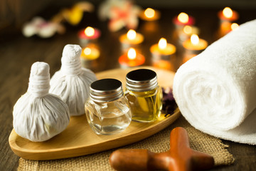 Selective focus Herbal compress balls with oil, towel, Massage wood on the wooden table in spa...
