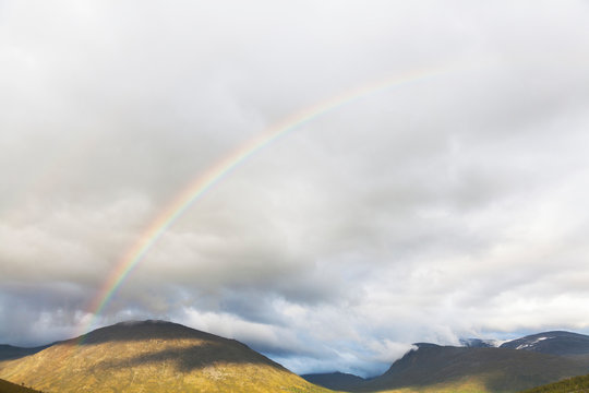 Rainbow over mountain landscape, Jotunheimen National Park, Lom, Oppland, Norway