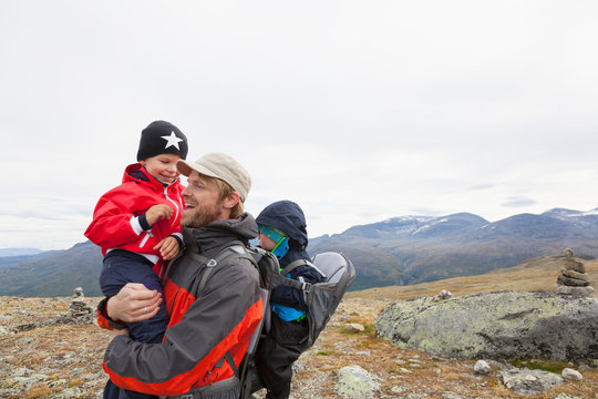 Male hiker with sons in mountain landscape, Jotunheimen National Park, Lom, Oppland, Norway