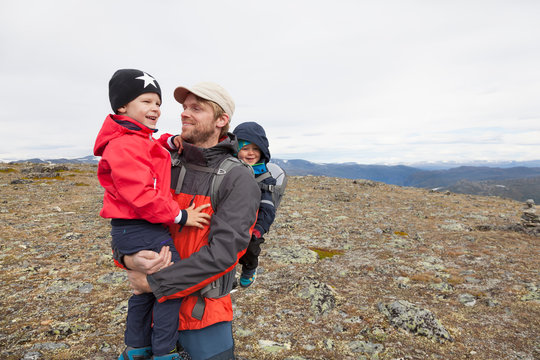 Male hiker with sons in mountain landscape, Jotunheimen National Park, Lom, Oppland, Norway