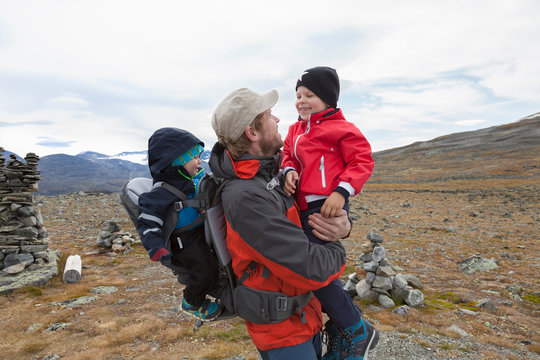 Male hiker with sons in mountain landscape, Jotunheimen National Park, Lom, Oppland, Norway