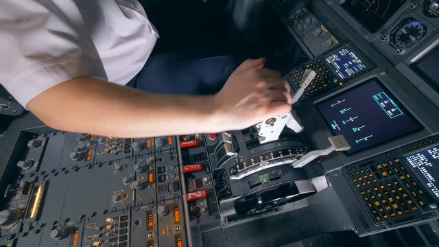 One pilot holds his hand on a plane lever in a flight simulator. 4K.