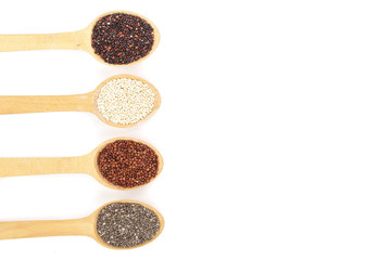 Black red white quinoa and chia seeds in wooden spoon isolated on white background with copy space for your text