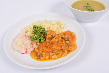 Seitan goulash with bulgur on a white