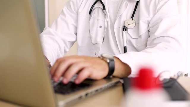 Doctor Typing On Laptop