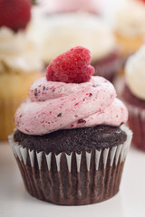 Chocolate Cupcake With Raspberry. Assorted Cupcakes In The Background.