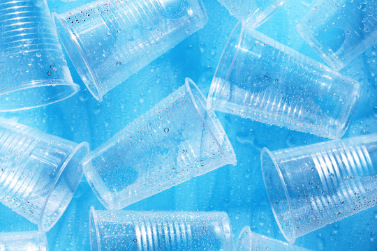 Disposable plastic cups on a blue background