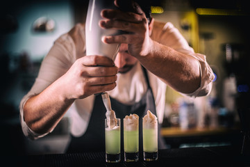 Bartender decorating shots