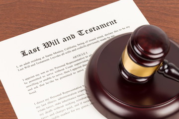 Last will and testament on yellowish paper with wooden judge gavel; document is mock-up