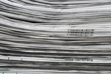 close up newspapers folded and stacked background and texture