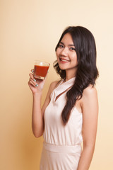 Young Asian woman drink tomato juice.