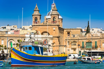 Fototapeta na wymiar Coloful boats in Marsaxlokk port in Malta