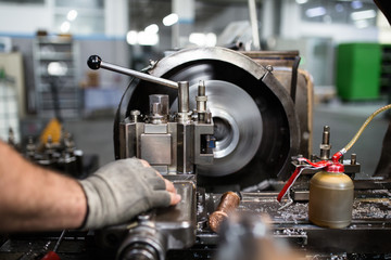 Metallurgy heavy industry. Factory for production of special industrial tools. Worker hands close up.
