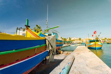 Fototapeta na wymiar Traditional painted fisherman boat in Marsaxlokk village,Malta