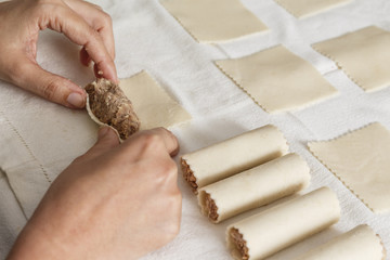 Woman making cannelloni in her kitchen