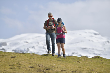 Obraz na płótnie Canvas Couple of hikers walking to the mountains