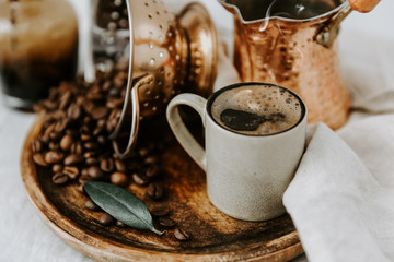 Turkish Coffee Pot and Coffee beens on linen table