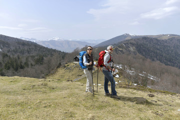 Fototapeta premium Couple on a trekking day in the mountain