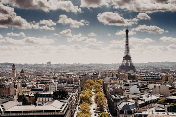 Fototapeta premium Panoramic view of capital of France Paris with Eiffel towel from above, beautiful cityscape, cloudy blue sky. Day with wonderful historical landsmark and builduings. Nice attractive city for tourists