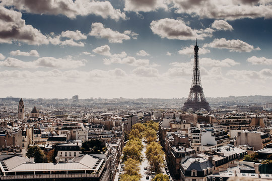 Panoramic view of capital of France Paris with Eiffel towel from above, beautiful cityscape, cloudy blue sky. Day with wonderful historical landsmark and builduings. Nice attractive city for tourists