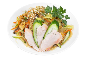 Rice noodles with smoked fried chicken and pieces of fresh cucumber. Dish isolated.