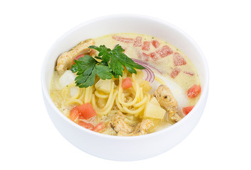 High angle view of Thai food - chicken and noodles in coconut milk soup isolated on white. Delicious soup with meat and noodles.