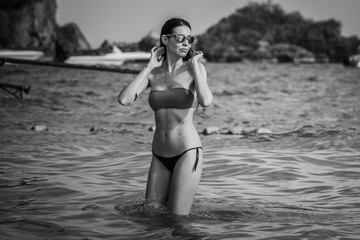 Young model, woman, bathing in Railay beach, popular travel destination near Krabi, Thailand.
