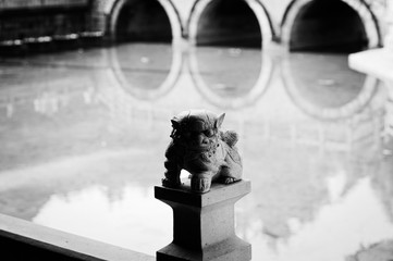Isolated gargoyle on the bridge and water reflection background - Yuantong Temple (Kunming, Yunnan, China)