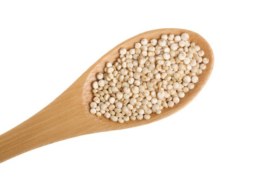 red quinoa seeds in wooden spoon isolated on white background. Top view