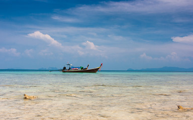 Traditional thai longtail boats on the beach of Ko Ngai, Koh Lanta, Thailand.