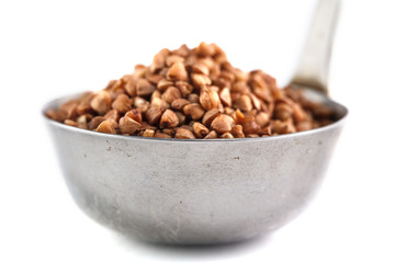 buckwheat in metal bucket on white background. Isolate