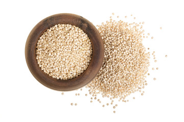 red quinoa seeds in wooden bowl isolated on white background. Top view