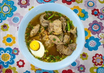 Marinated pork and egg soup at a street food stall at the weekend market, Phuket, Thailand