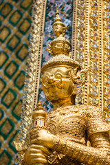 Fototapeta na wymiar Golden statue at the Wat Phra Kaew Palace, also known as the Emerald Buddha Temple. Bangkok, Thailand.