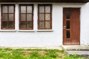Fototapeta na wymiar Three windows and a door