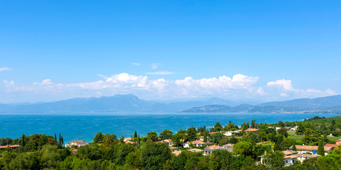 View of Lake Garda, summer landscape. Blue lake, mountayns Alps.  Castelnuovo del Garda, Italy - Agust 31 2016: Gardaland Theme Amusement Park in Castelnuovo Del Garda, Verona, Italy..