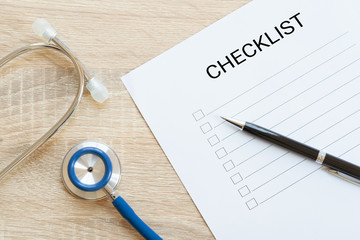 Hands writing checklist with annual health and stethoscope - to do list, goal