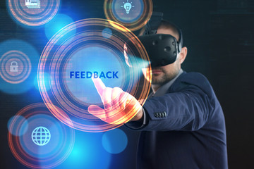 Fototapeta na wymiar Business, Technology, Internet and network concept. Young businessman working in virtual reality glasses sees the inscription: Feedback
