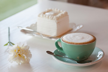 Coffee and cake on a white table.