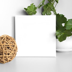 Blank square white canvas in the interior. Gray wall on background.