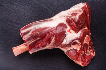 fresh lamb meat on a textured stone plate