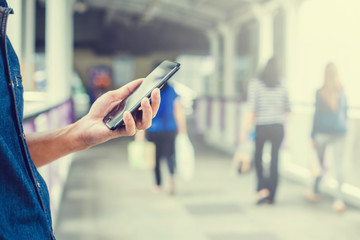 Close-up view of an Asian businessman using digital smart phone in the city