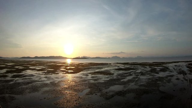 4K Sunset time-lapse landscape of incoming tide taking over the beach at Phuket, Thailand