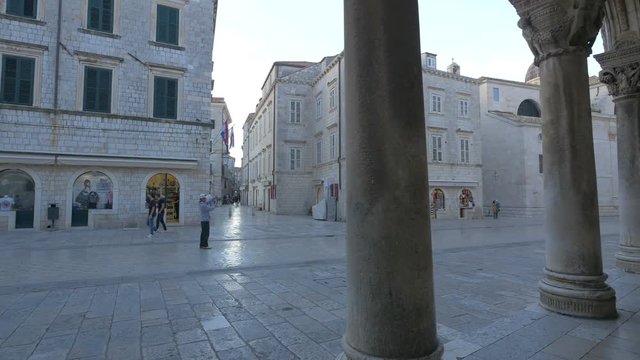 A city street seen from behind columns