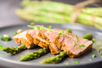 Roasted pork tenderloin and asparagus - close up