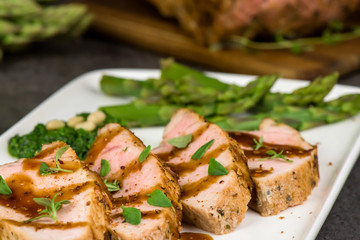 Roasted pork tenderloin and asparagus - close up