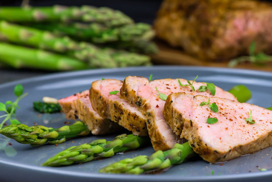 Roasted pork tenderloin and asparagus - close up