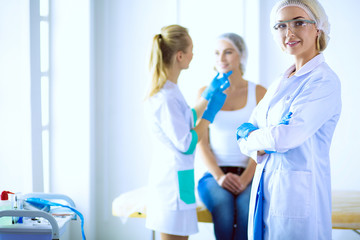 Fototapeta premium Beautiful woman face near doctor with syringe