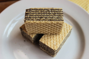 Waffles are on a white plate, dessert, close-up